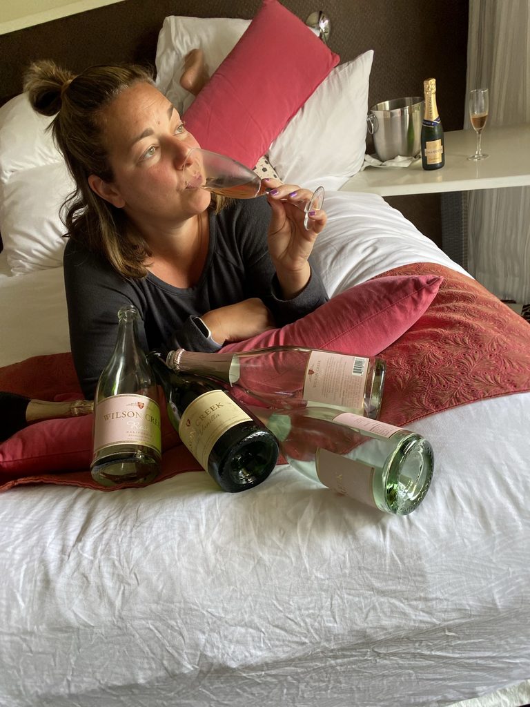 Woman drinking champagne in bed